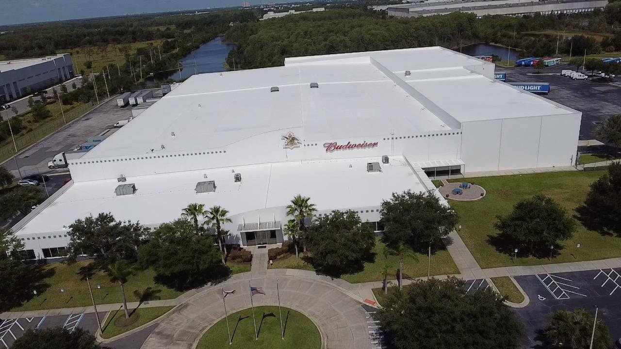 Restored white reflective TPO roof on the City Beverage distribution facility in Orlando, Florida